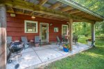 Covered Porch with Outdoor Dining Table and Charcoal Grill